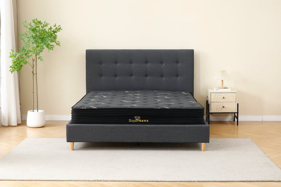 Dark grey upholstered bed and mattress package for a guest room
