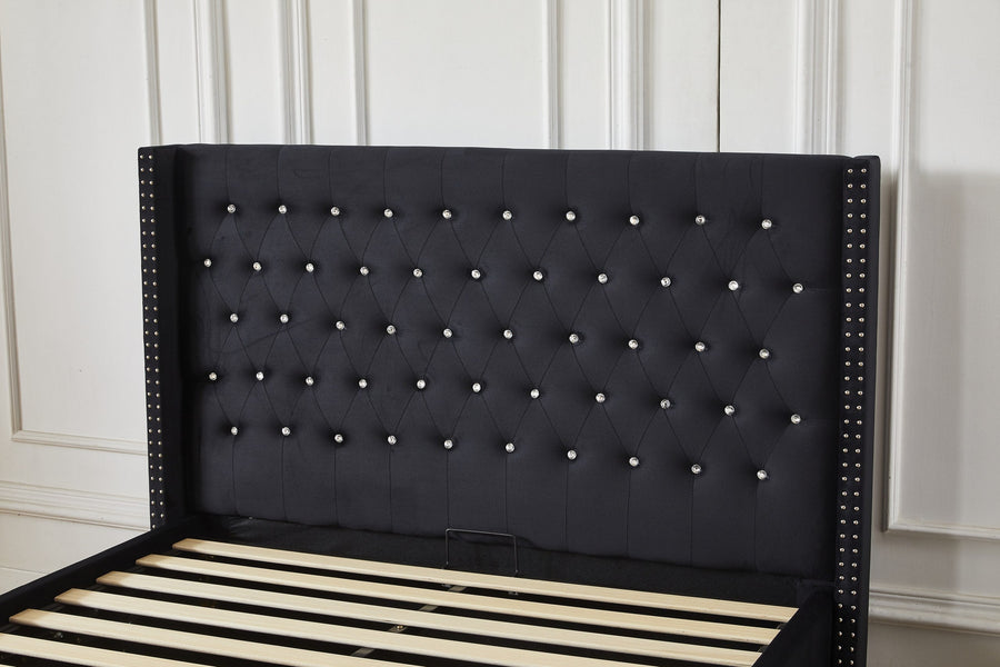 Black upholstered bed frame with crystal-button headboard in a bedroom