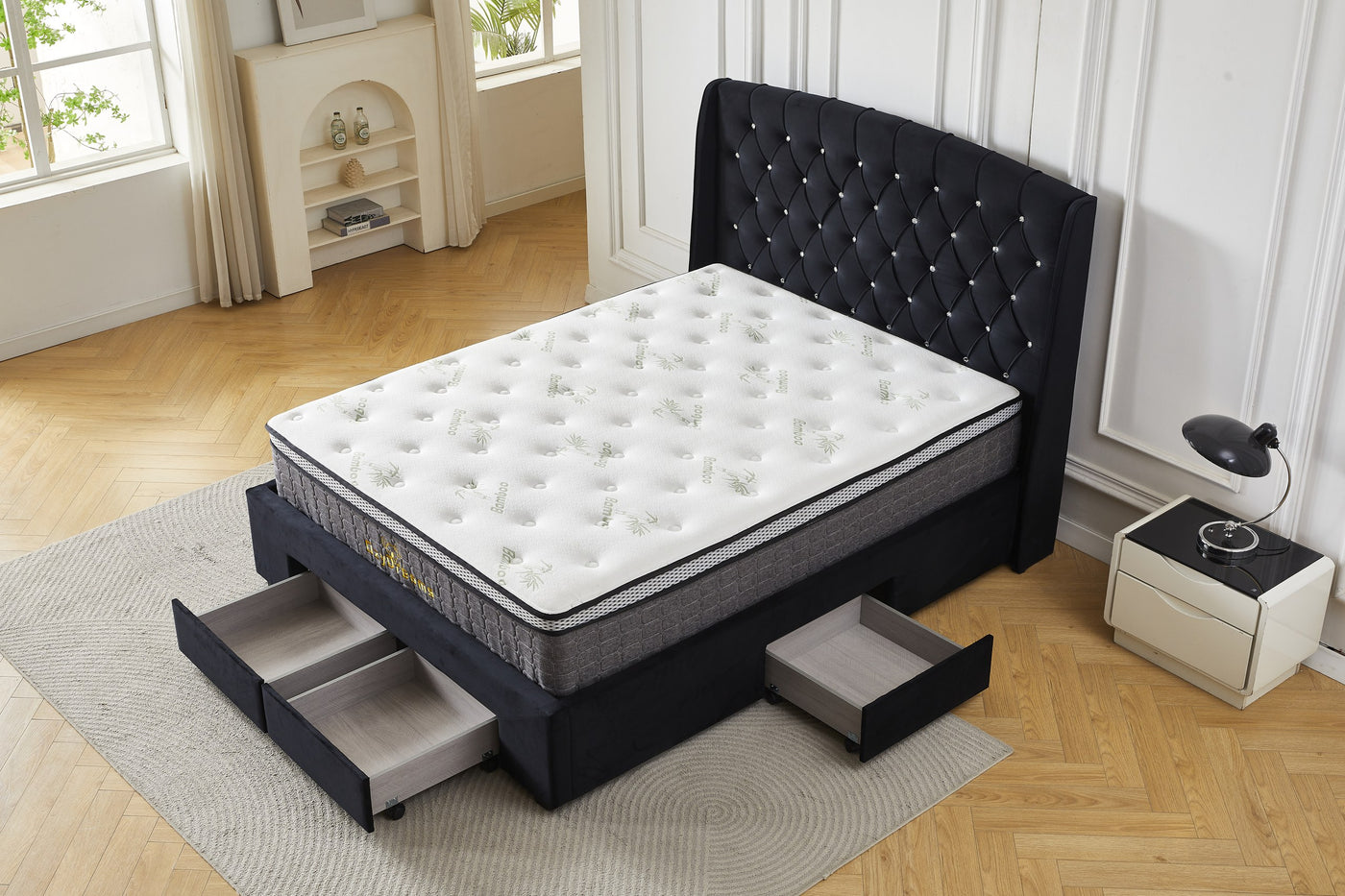 Black four-drawer tufted bed frame and bamboo mattress package, high angled view with drawers open