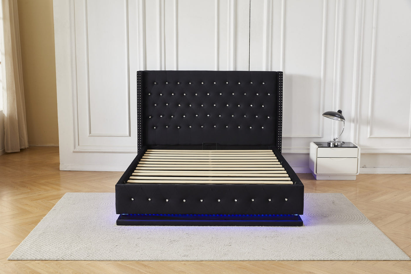 Black crystal tufted gas lift storage bed frame with blue LED base lighting, front view