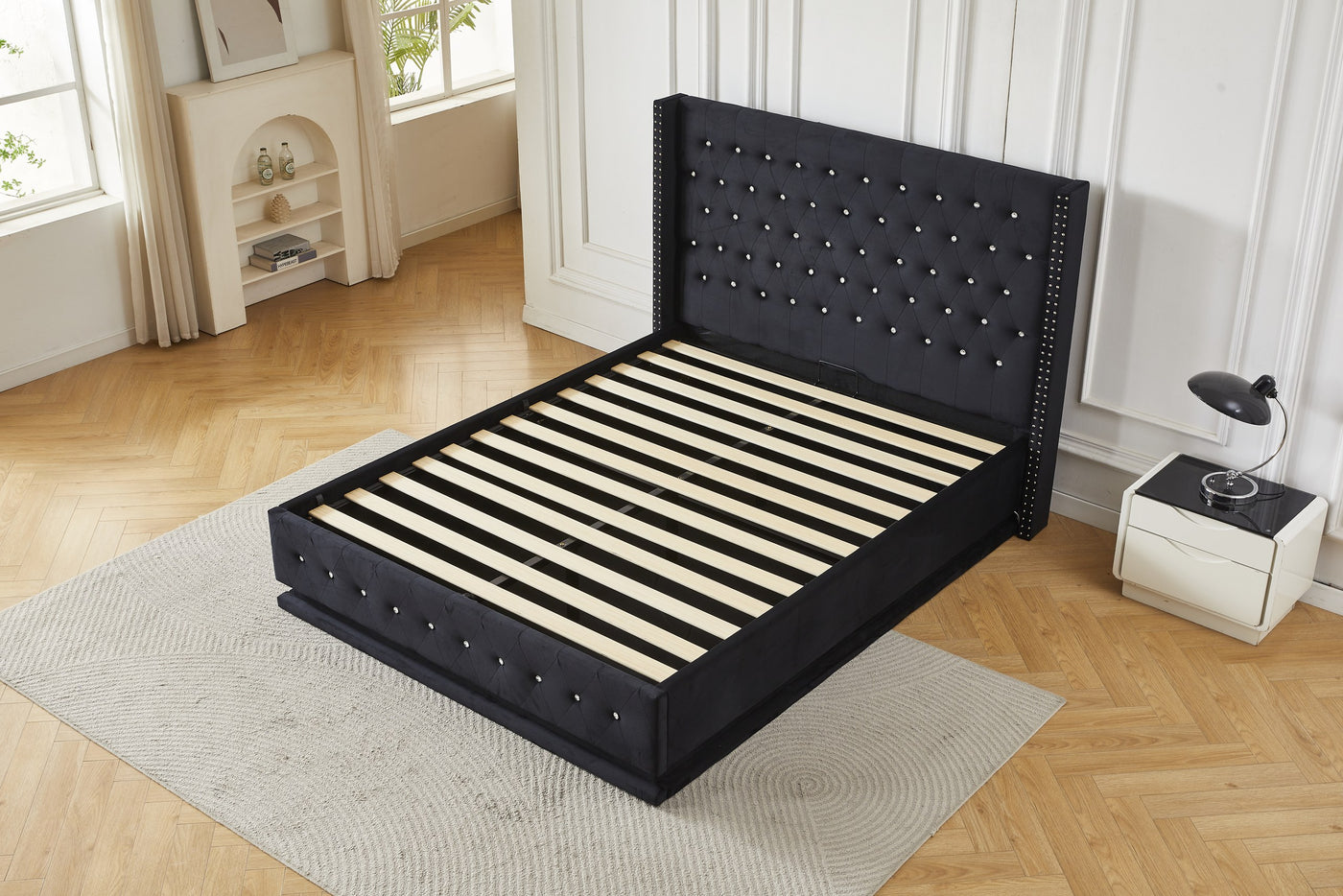 Black crystal tufted gas lift storage bed frame, elevated angled view