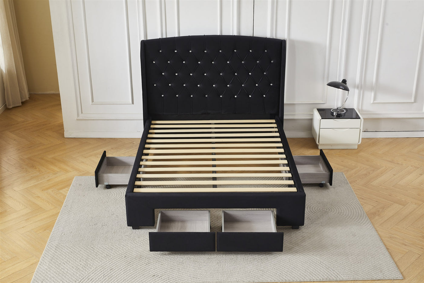 Black bed frame with front and side drawers open