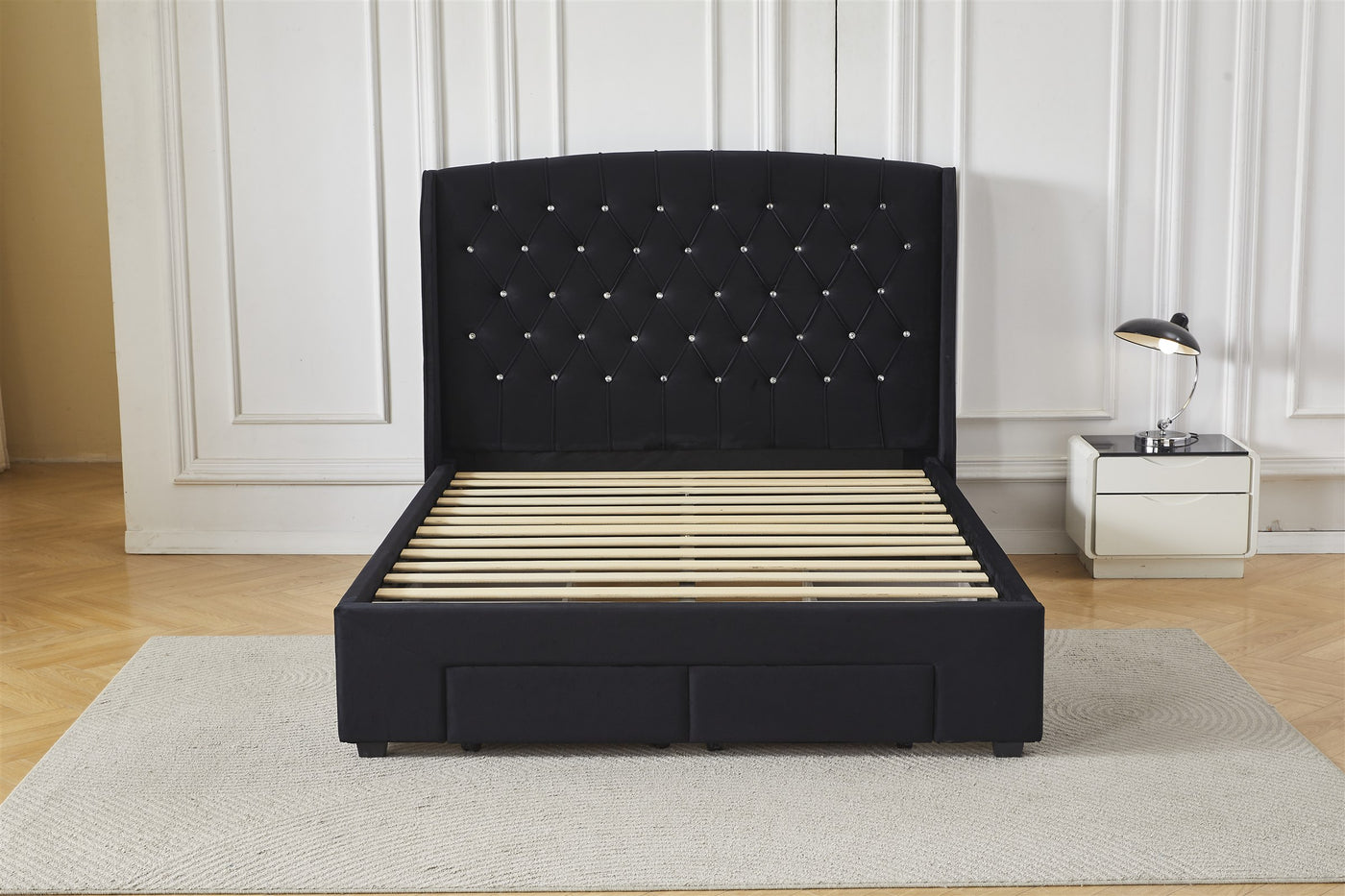 Black tufted bed frame with drawers, front view