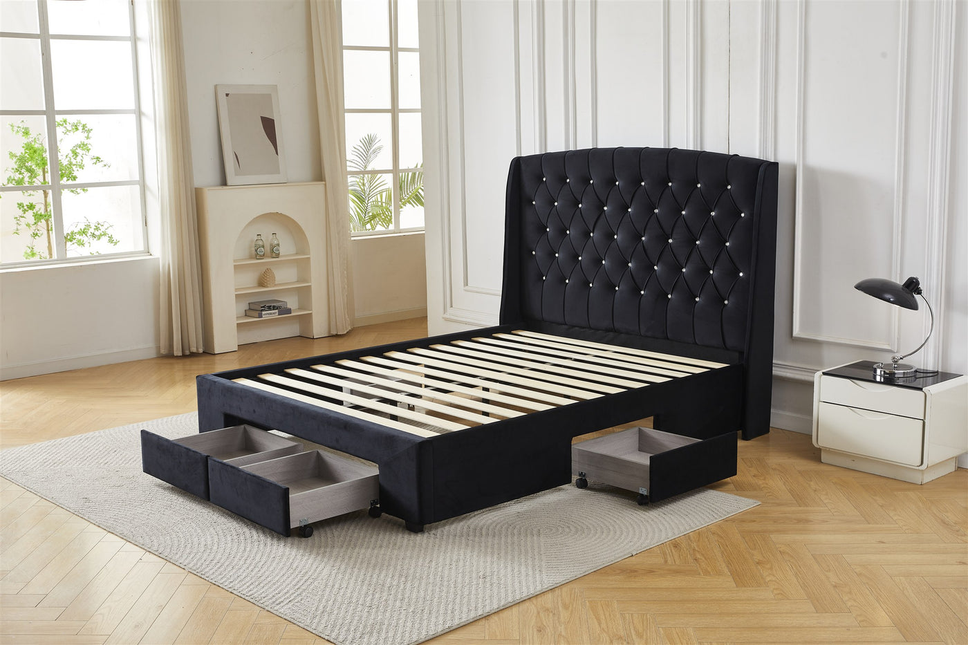 Black tufted bed frame with drawers, angled front view
